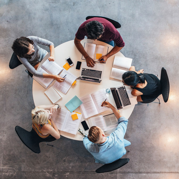 Four people working at a round table