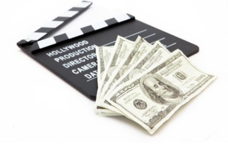 film slate and paper money representing the cost of video learning