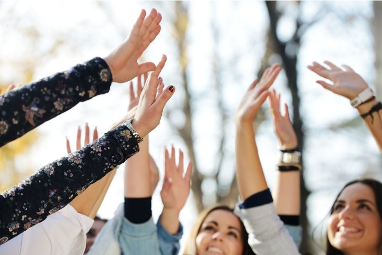 employee recognition in the form of people giving high fives.