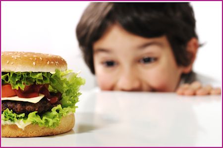 child admiring a cheeseburger