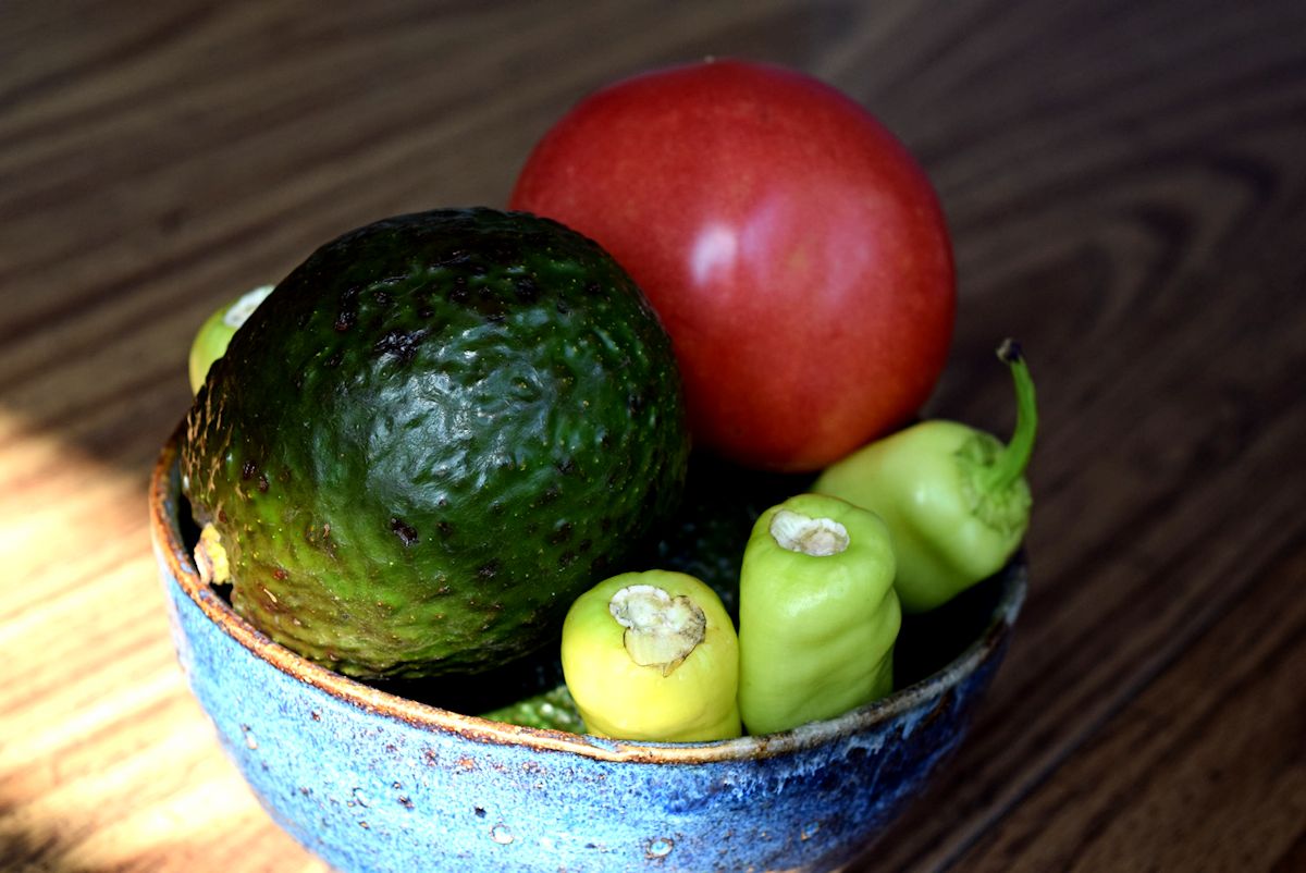 Avocado, tomato and peppers in a bowl